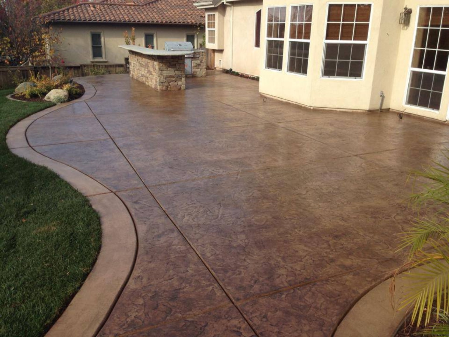 Decorative stamped concrete patio with curved edges