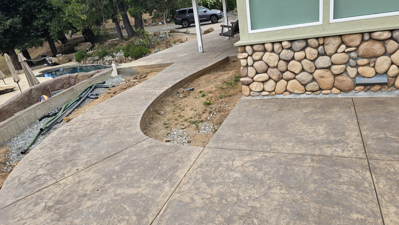 Stamped concrete walkway and patio with natural stone architecture