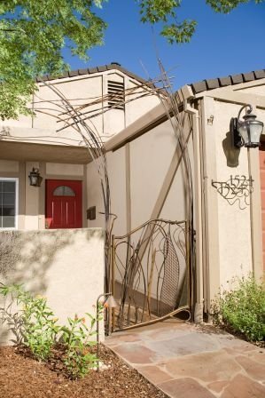 Custom artistic metal gate integrated into landscape design